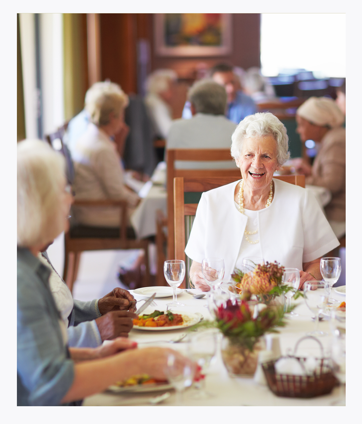 Seniors eating in long-term care dining room with 24 hour support, activity of daily living nursing home
